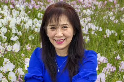 Portrait of a smiling young woman on field