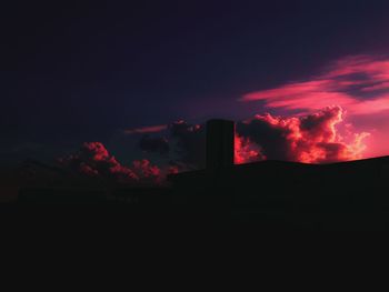 Low angle view of smoke from smoke stack at night