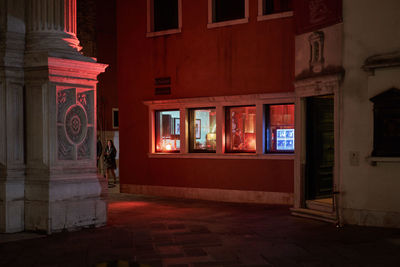 Illuminated building by street light at night