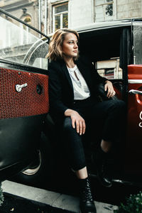 Young woman sitting on seat in bus
