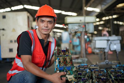 Portrait of male worker standing in the heavy industry manufacturing factory.