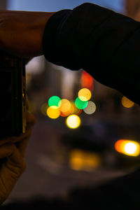 Close-up of hand holding illuminated lights