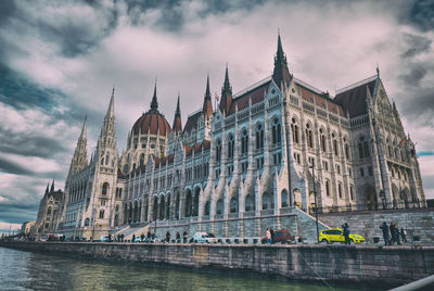 Low angle view of building against cloudy sky