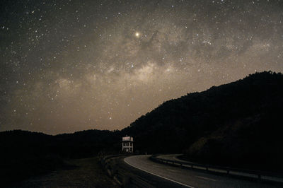 Scenic view of road against sky at night