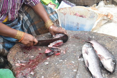 Midsection of person holding fish at market