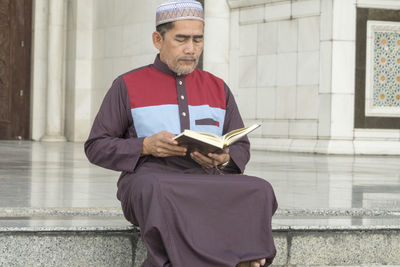 Full length of a man reading book