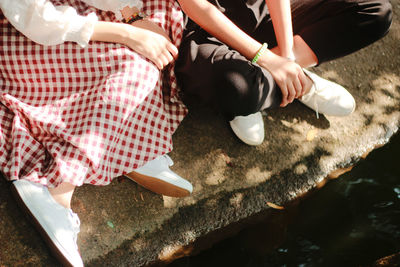 Close-up of woman relaxing on wall