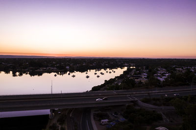 High angle view of bridge over sea against sky at sunset