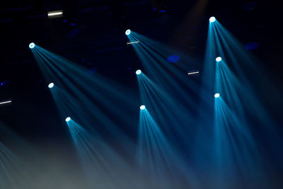 Stage lights glowing in the dark at a live concert. music festival concept