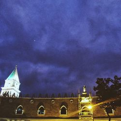 Low angle view of church against cloudy sky
