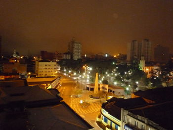 High angle view of illuminated buildings against sky at night