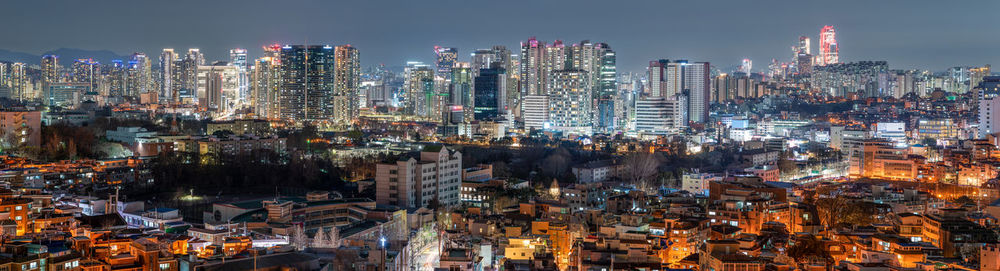 High angle view of illuminated buildings in city at night