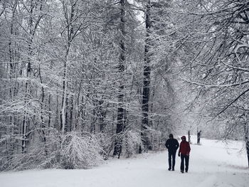 People walking on snow covered landscape