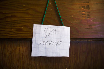 A small homemade sign in child's handwriting reads, "out of service"