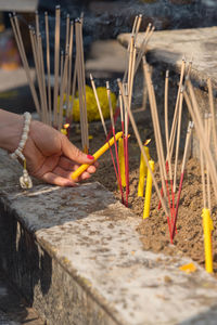 Close-up of man holding cross in temple