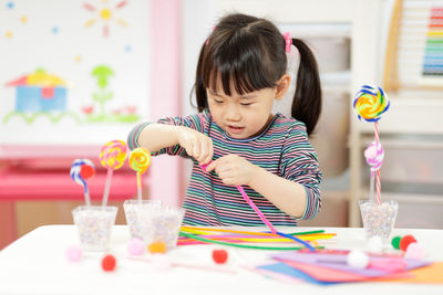 Young girl making craft for homeschooling