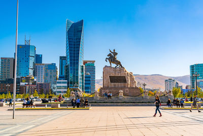 Statue of buildings against blue sky