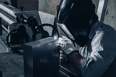 Laser welding process close up. worker in protective clothing welds metal with laser.