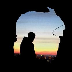 Silhouette built structures at sunset