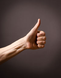 Close-up of man hand against colored background