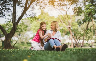 Mother and son sitting on tree