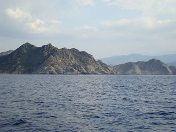 Scenic view of mountains against cloudy sky