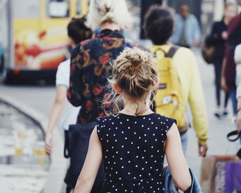 Rear view of a girl walking on street