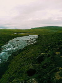 Scenic view of landscape against cloudy sky