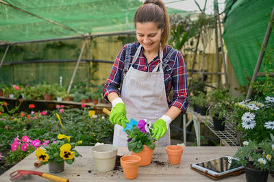 Portrait of man holding potted plant