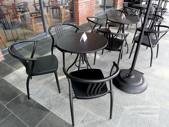 High angle view of empty chairs and table in restaurant