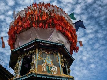 Low angle view of temple against cloudy sky