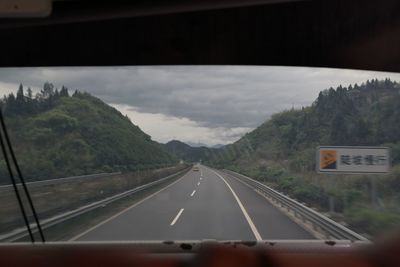 View of road seen through car windshield