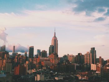 Skyscrapers against cloudy sky