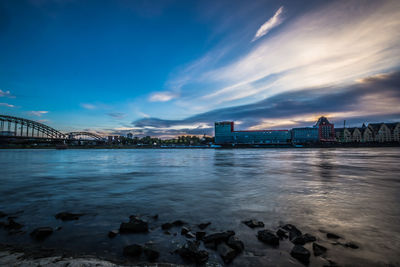 View of bridge over river against cloudy sky