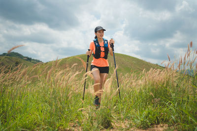 Rear view of woman standing on field