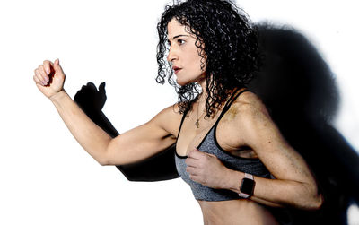 Portrait of woman standing against white background