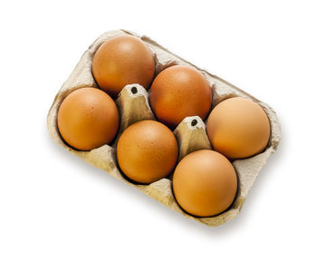 High angle view of eggs in container against white background