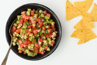 High angle view of chopped fruits in bowl on table