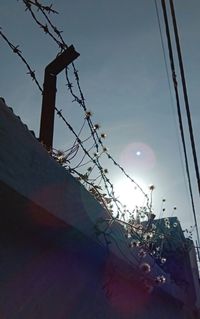 Low angle view of telephone pole against sky