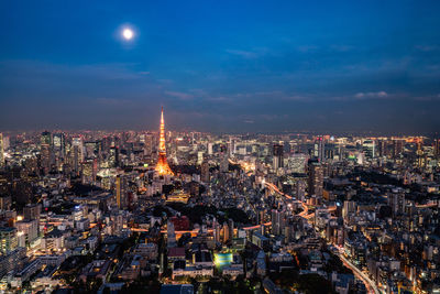 Aerial view of illuminated buildings in city at night