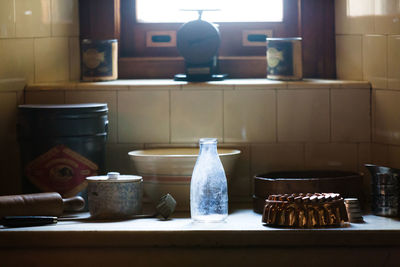 Bottle with kitchen utensils on kitchen counter