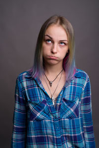 Portrait of a beautiful young woman over black background