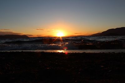 Scenic view of sea against clear sky during sunset