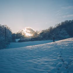 Scenic view of snow covered landscape against sky