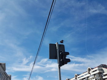 Low angle view of telephone pole against sky