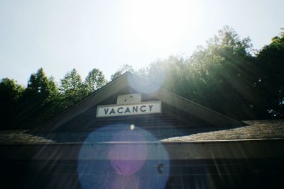 Close-up of text on tree against sky