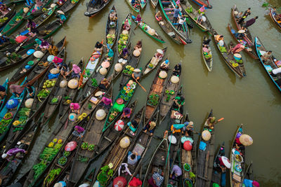 High angle view of people on boat in river at market