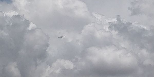 Low angle view of airplane flying in sky