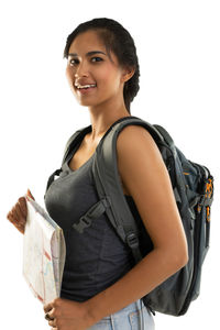 Portrait of smiling young woman against white background