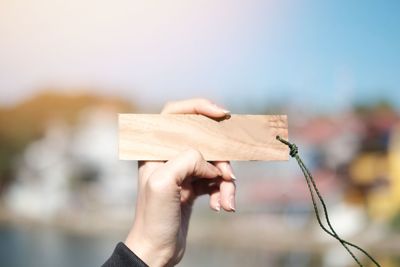 Close-up of woman hand holding wood